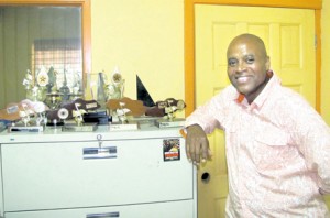 Donovan Germain displays the various awards Penthouse Records has won over the years.